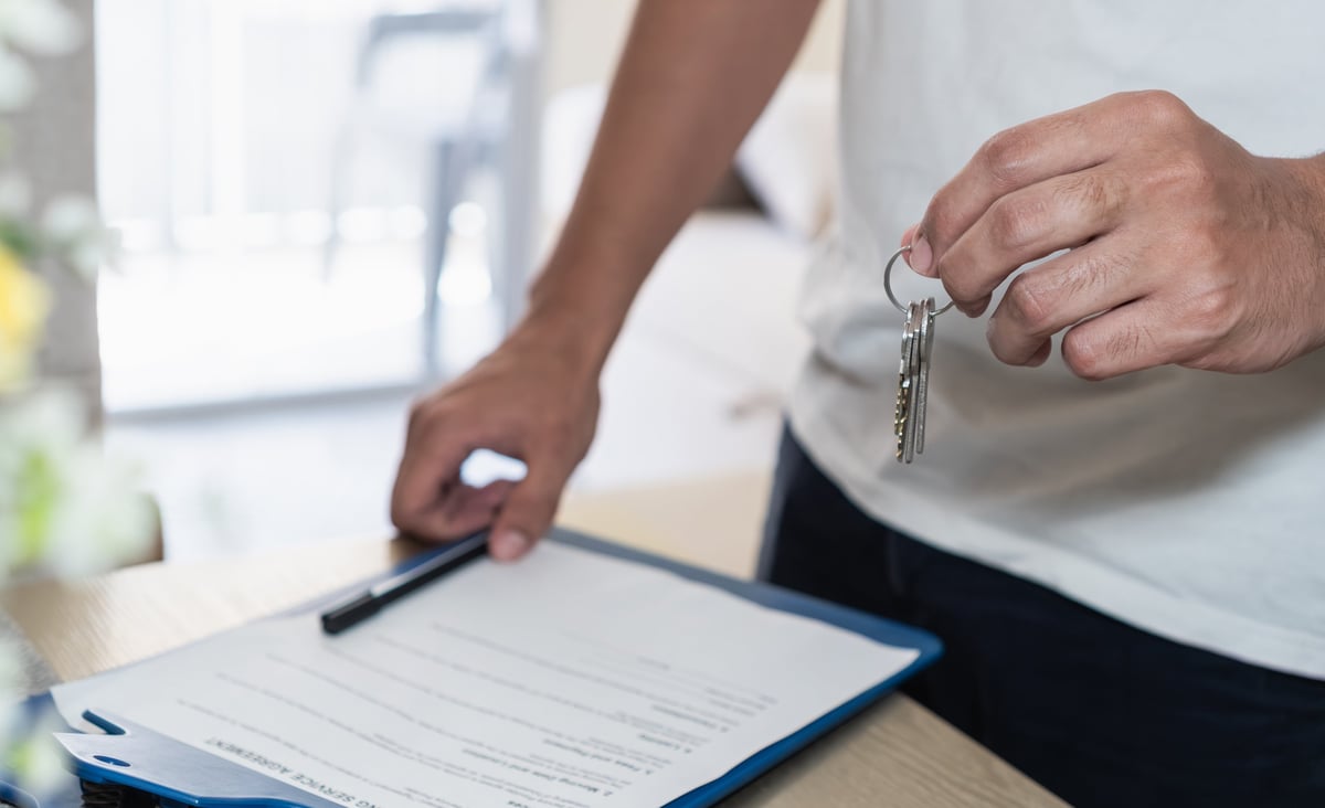 A person holding the keys to a recently sold property